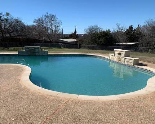 freeform pool with a water feature