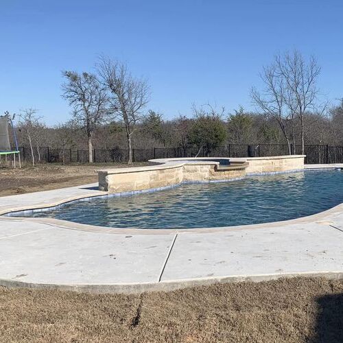 a pool with a water fountain feature